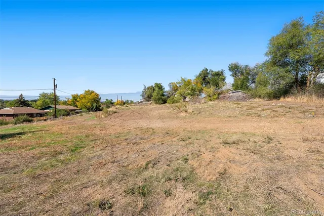 a view of beach and small yard