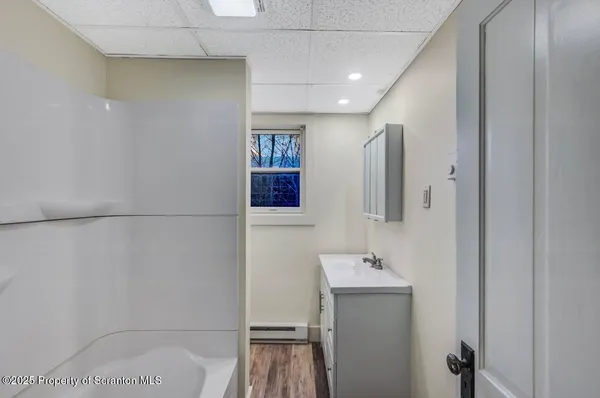 a bathroom with a sink and mirror