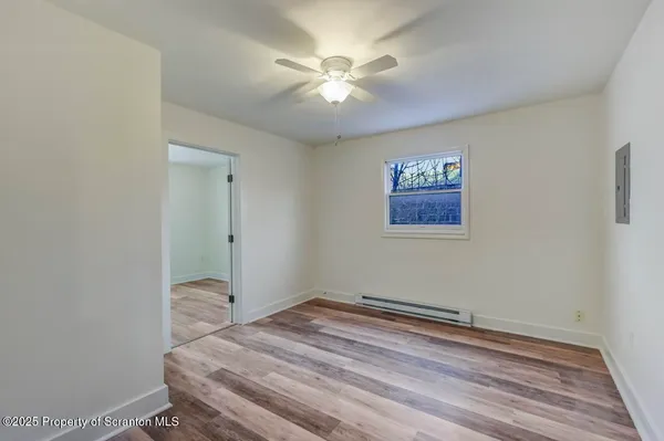 a view of room with window and ceiling fan