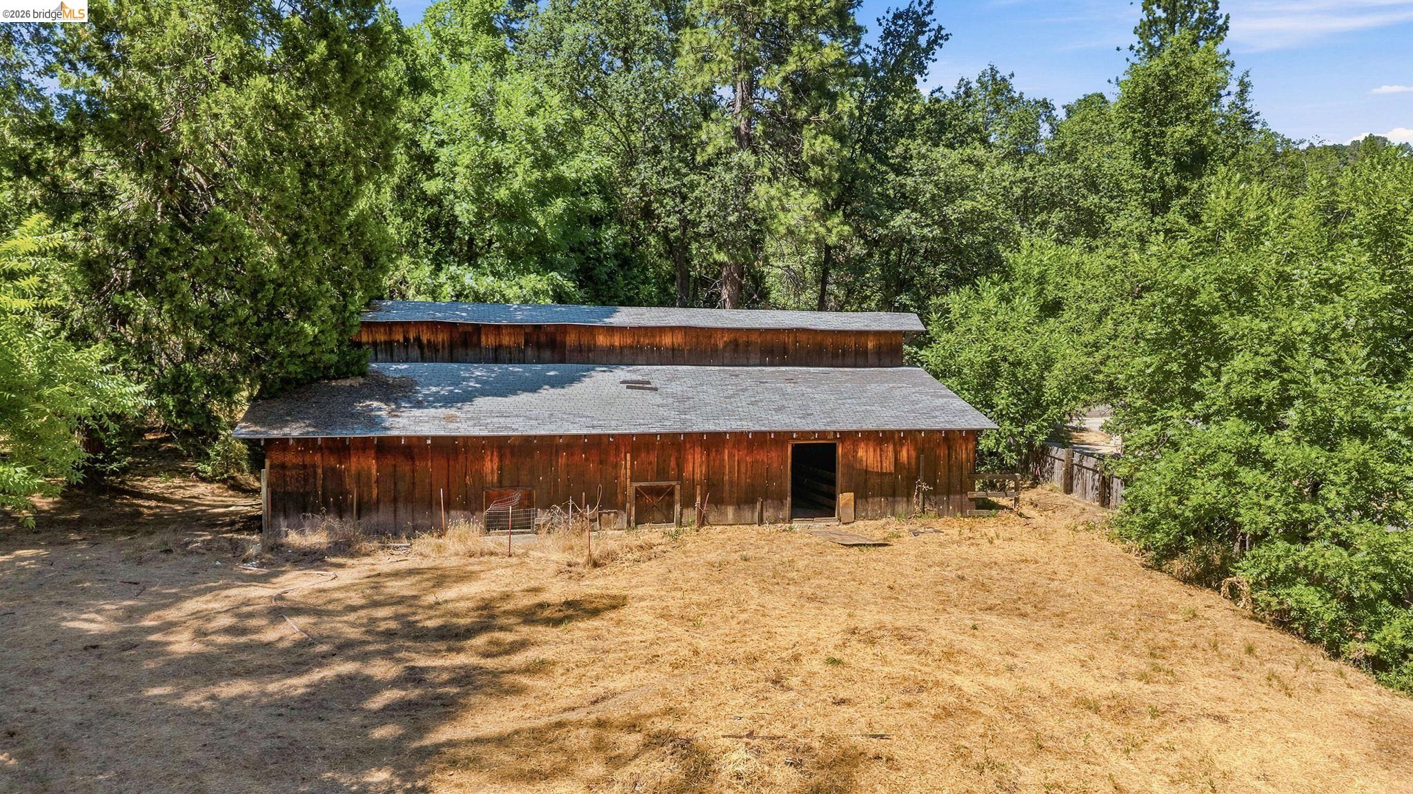22401 South Fork Road Sonora, CA 95370 - Photo 31 of 34 Rustic barn structure featuring natural wood siding and a gabled roofline