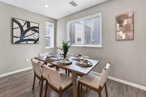 a kitchen with counter top space a sink wooden floor and stainless steel appliances
