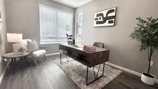 a bedroom with bed and a large window