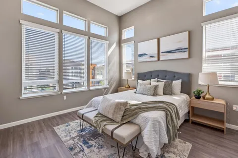 a bedroom with a large bed and a chandelier