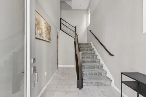 a view of entryway with stairs and wooden floor