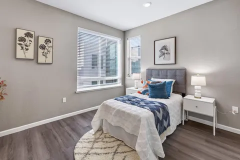 a bedroom with a bed and a painting