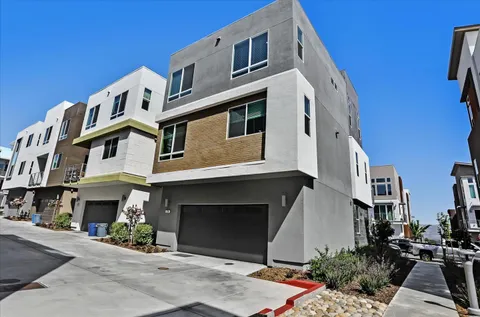 a front view of a multi story building with yard