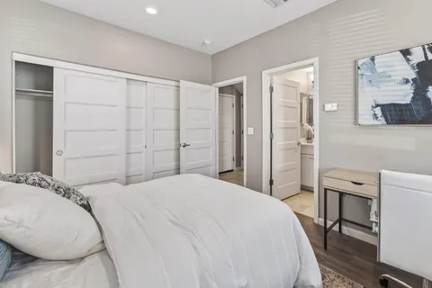 a spacious bedroom with a bed and a table