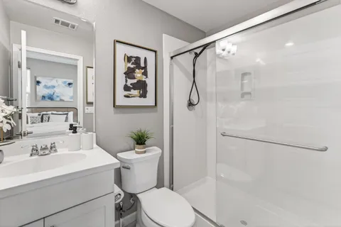 a bathroom with a sink toilet and shower