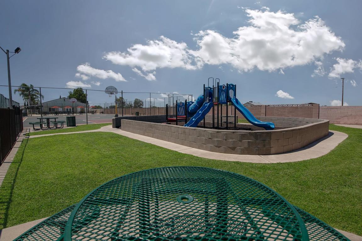 900 East Rankin Road, Unit 5 Tulare, CA 93274 - Photo 23 of 26 a view of a swimming pool with a garden