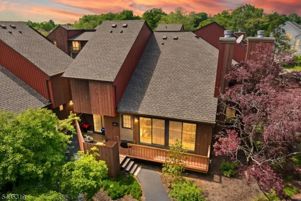an aerial view of a house with balcony and garden space