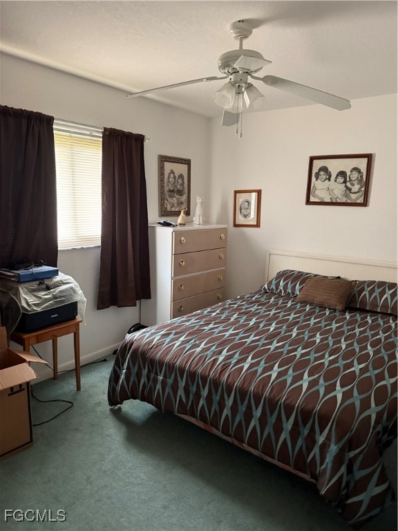 2260 Thompson Road Alva, FL 33920 - Photo 12 of 13 a bedroom with a bed and a chandelier