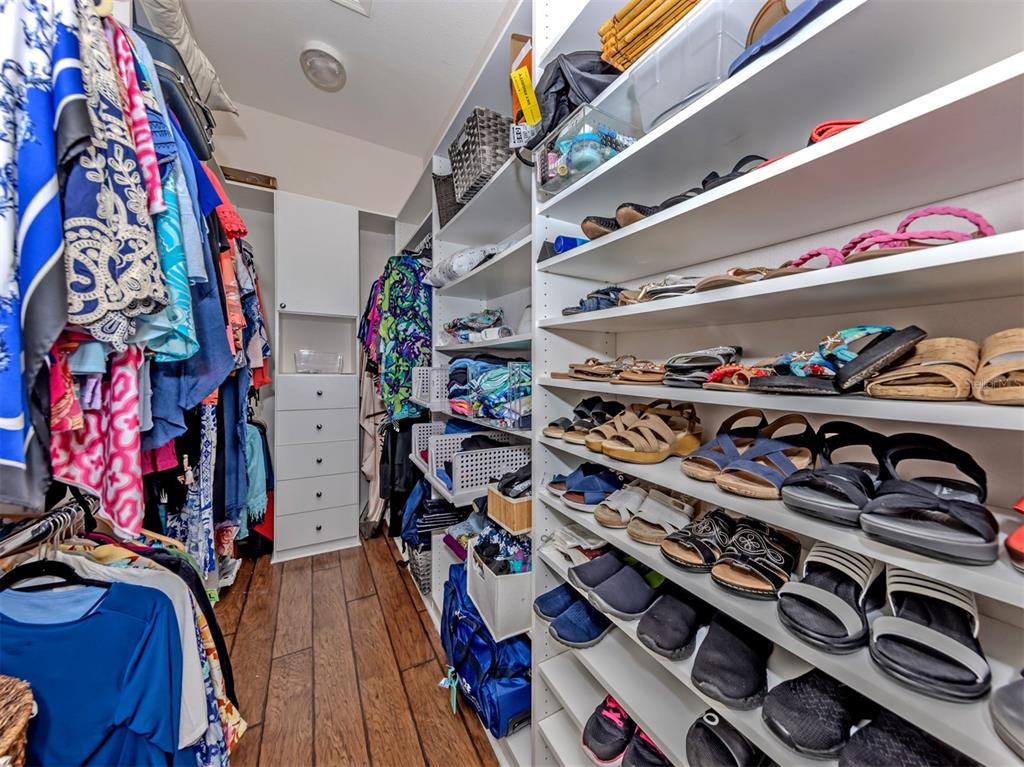 205 Reclinata Circle Venice, FL 34292 - Photo 27 of 62 a view of walk in closet with clothes and shoes