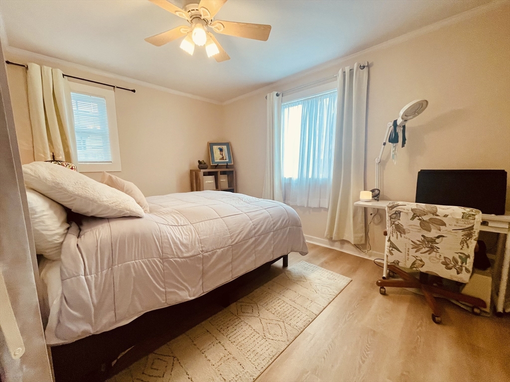41 Cohasset Road Buzzards Bay, MA 02532 - Photo 12 of 30 a bedroom with a bed and a chandelier