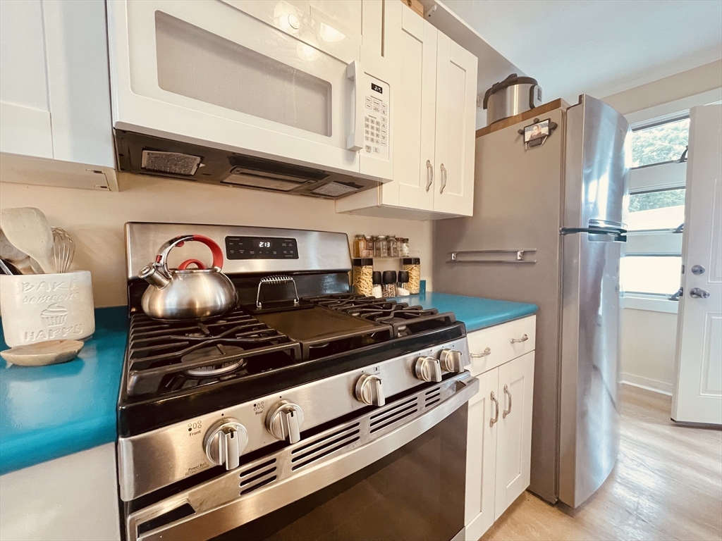 41 Cohasset Road Buzzards Bay, MA 02532 - Photo 9 of 30 a kitchen with stainless steel appliances granite countertop a stove and a refrigerator