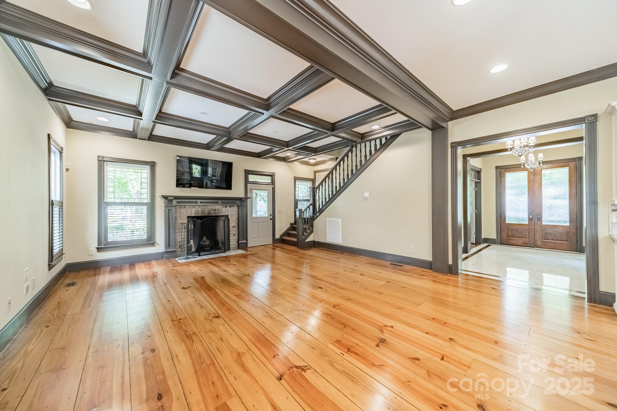 406 Bull Finch Bend Fort Mill, SC 29708 - Photo 12 of 48 a view of empty room with wooden floor and fireplace