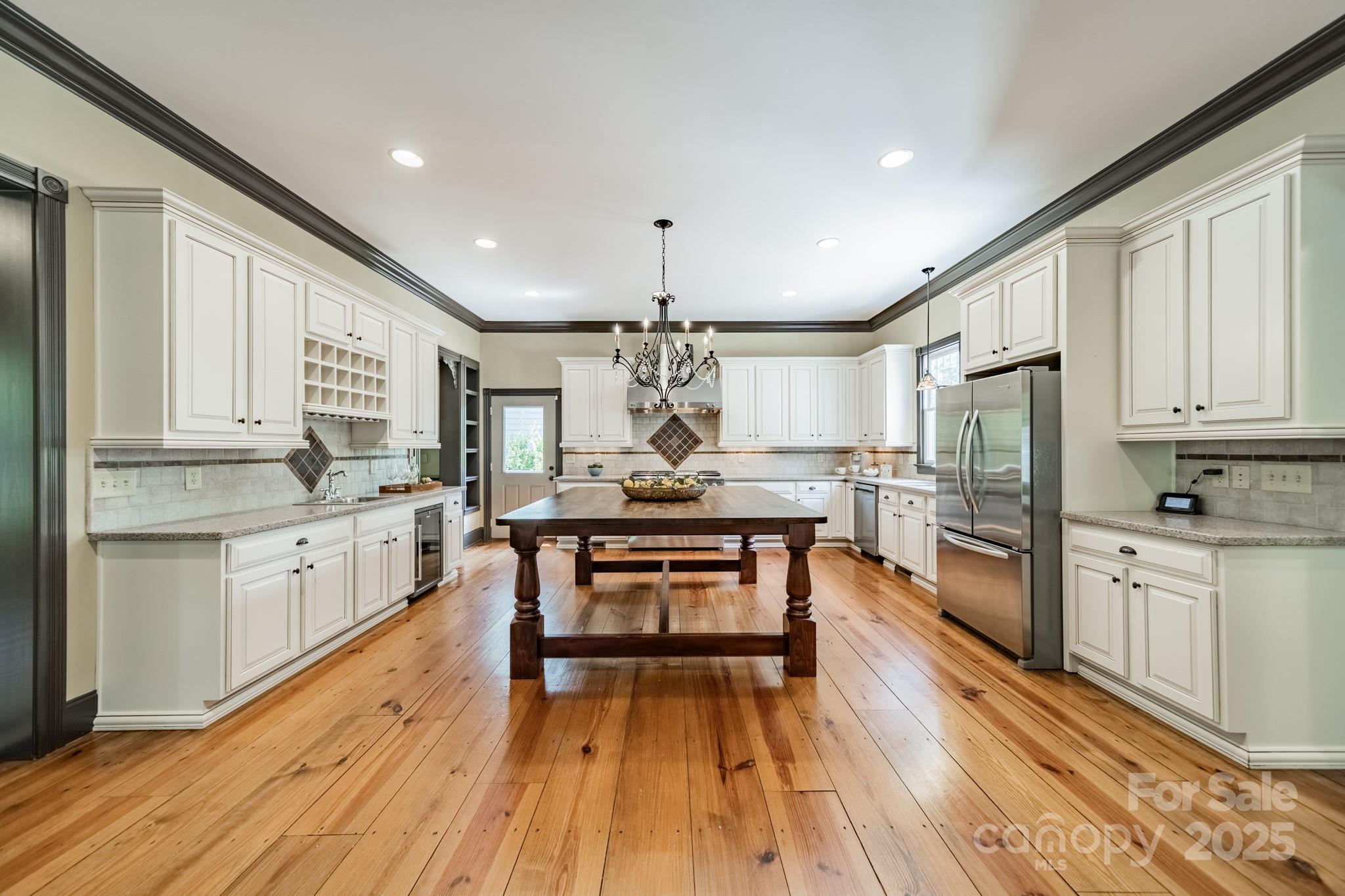 406 Bull Finch Bend Fort Mill, SC 29708 - Photo 13 of 48 a kitchen with stainless steel appliances granite countertop refrigerator oven cabinets dining table and chairs