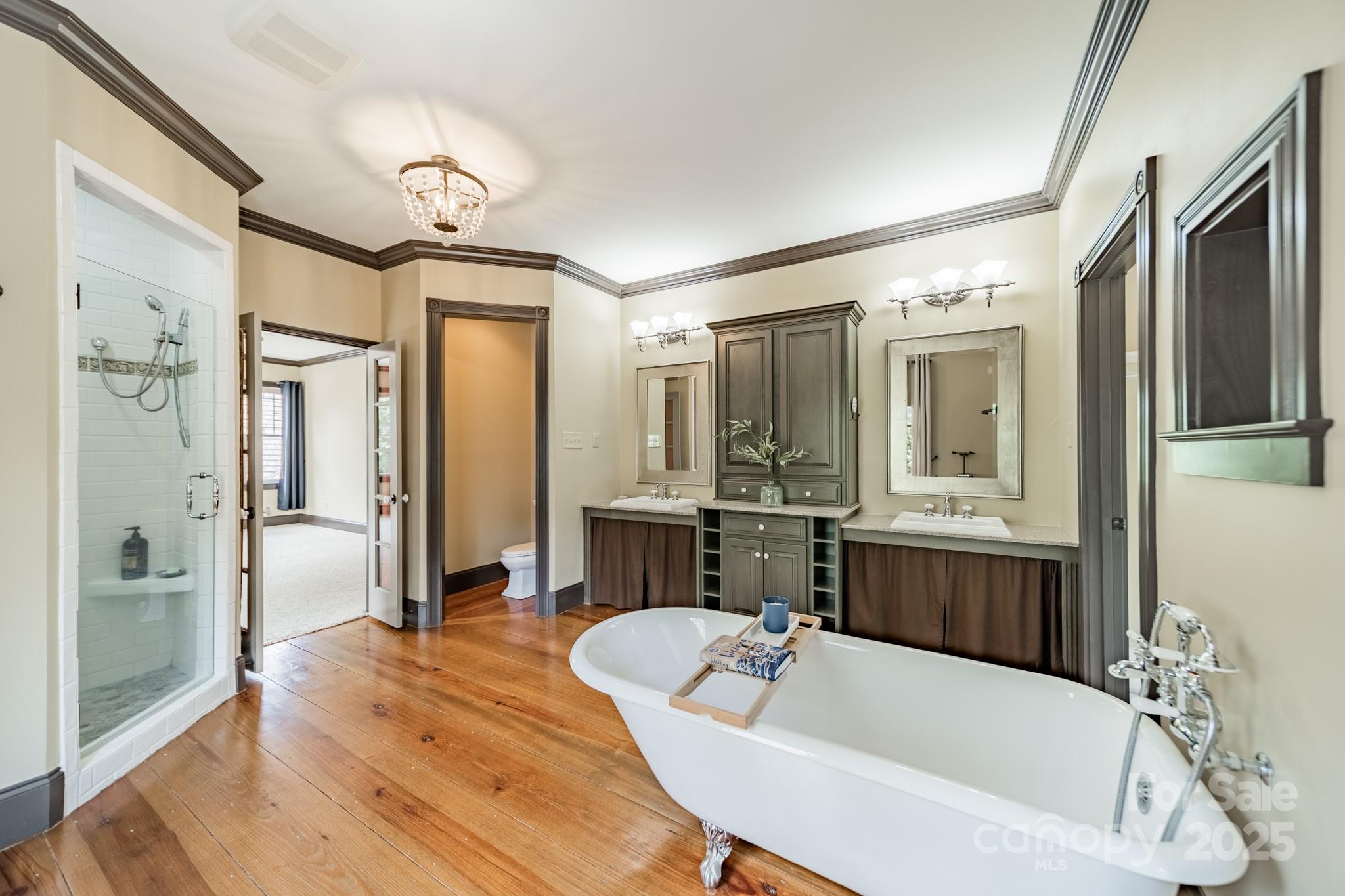 406 Bull Finch Bend Fort Mill, SC 29708 - Photo 29 of 48 a bathroom with a tub a sink shower and mirror