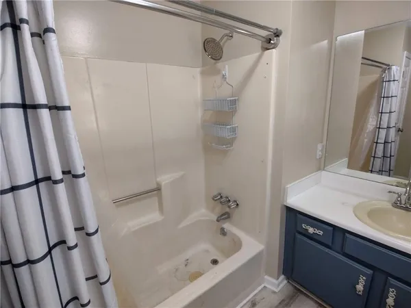 a bathroom with a sink a bathtub and a shower