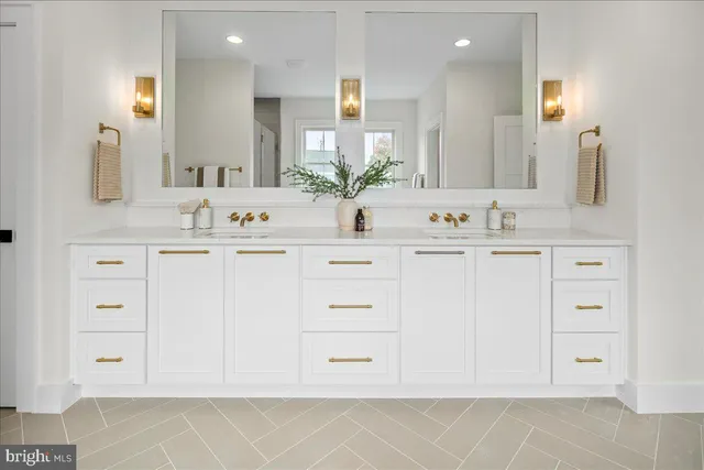 a bathroom with a sink vanity and mirror