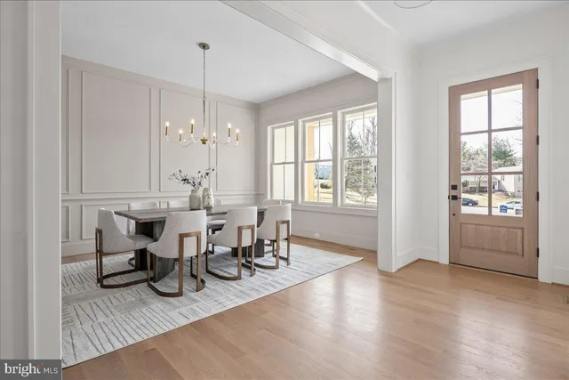 a view of a a dining room with furniture window and wooden floor