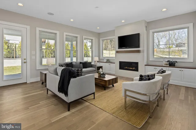 a living room with furniture fireplace and window