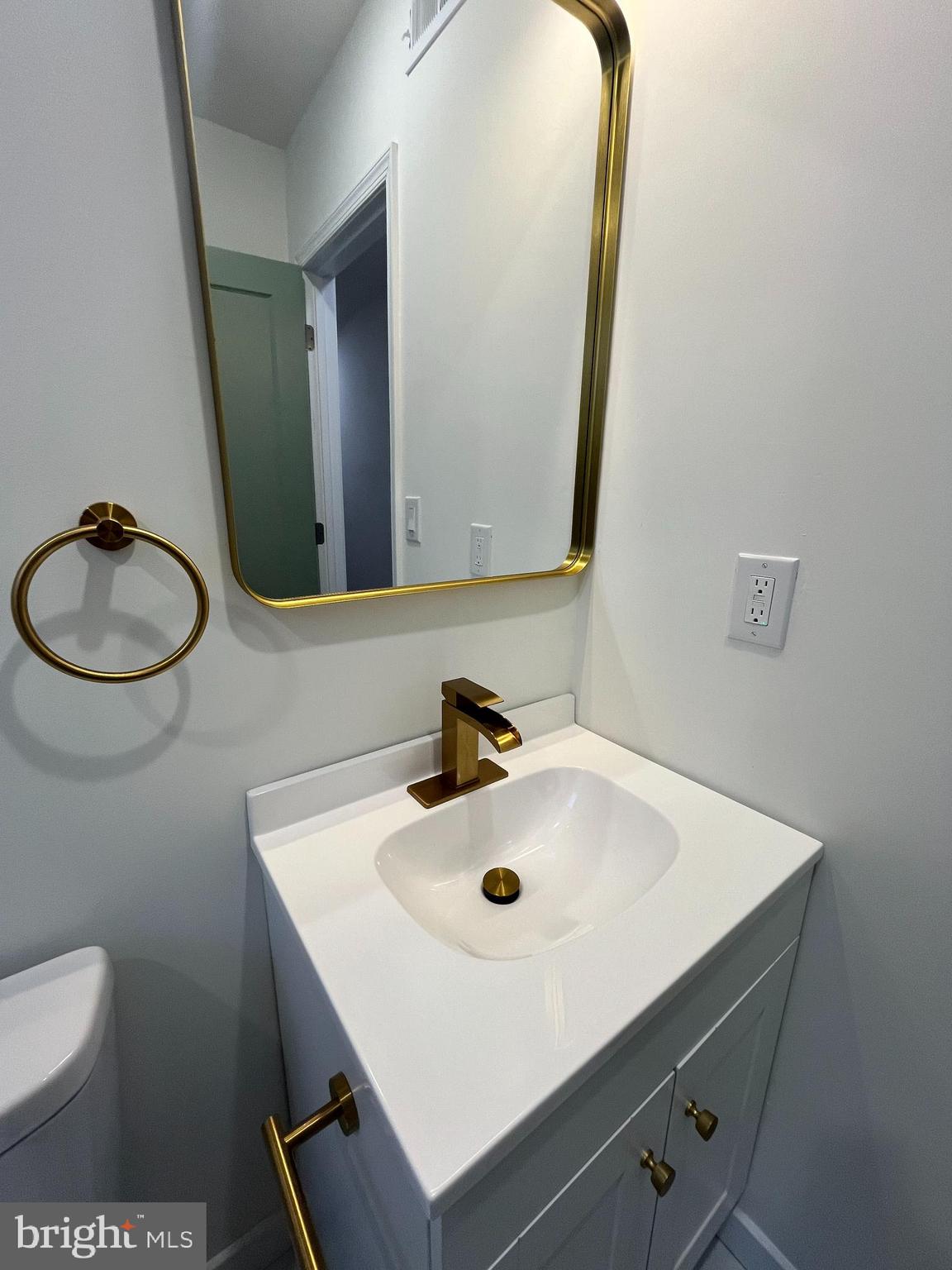 5712 Cedar Avenue Philadelphia, PA 19143 - Photo 32 of 56 a bathroom with a sink a toilet and mirror