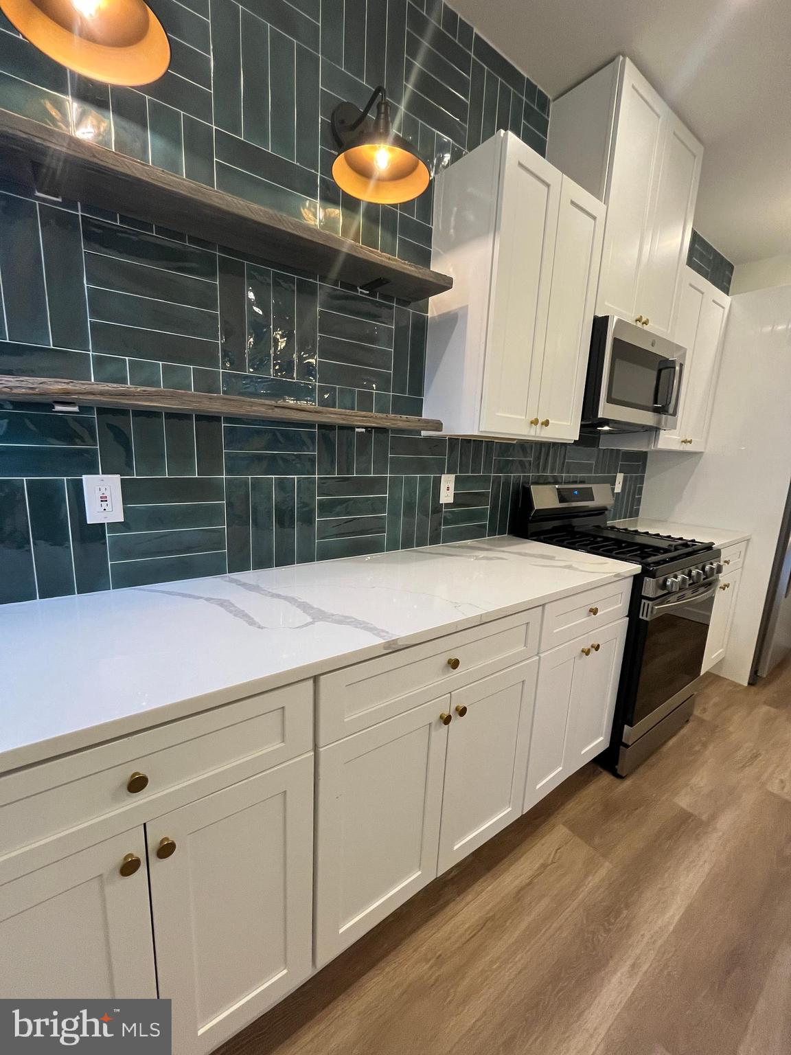 5712 Cedar Avenue Philadelphia, PA 19143 - Photo 4 of 56 a kitchen with stainless steel appliances a sink and cabinets