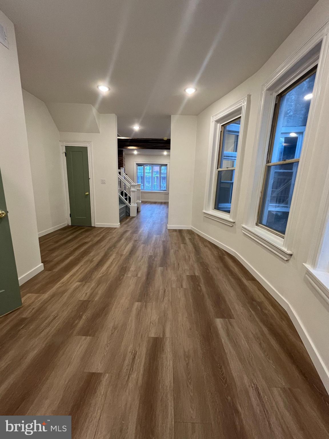 5712 Cedar Avenue Philadelphia, PA 19143 - Photo 10 of 56 a view of a hallway with wooden floor and a kitchen
