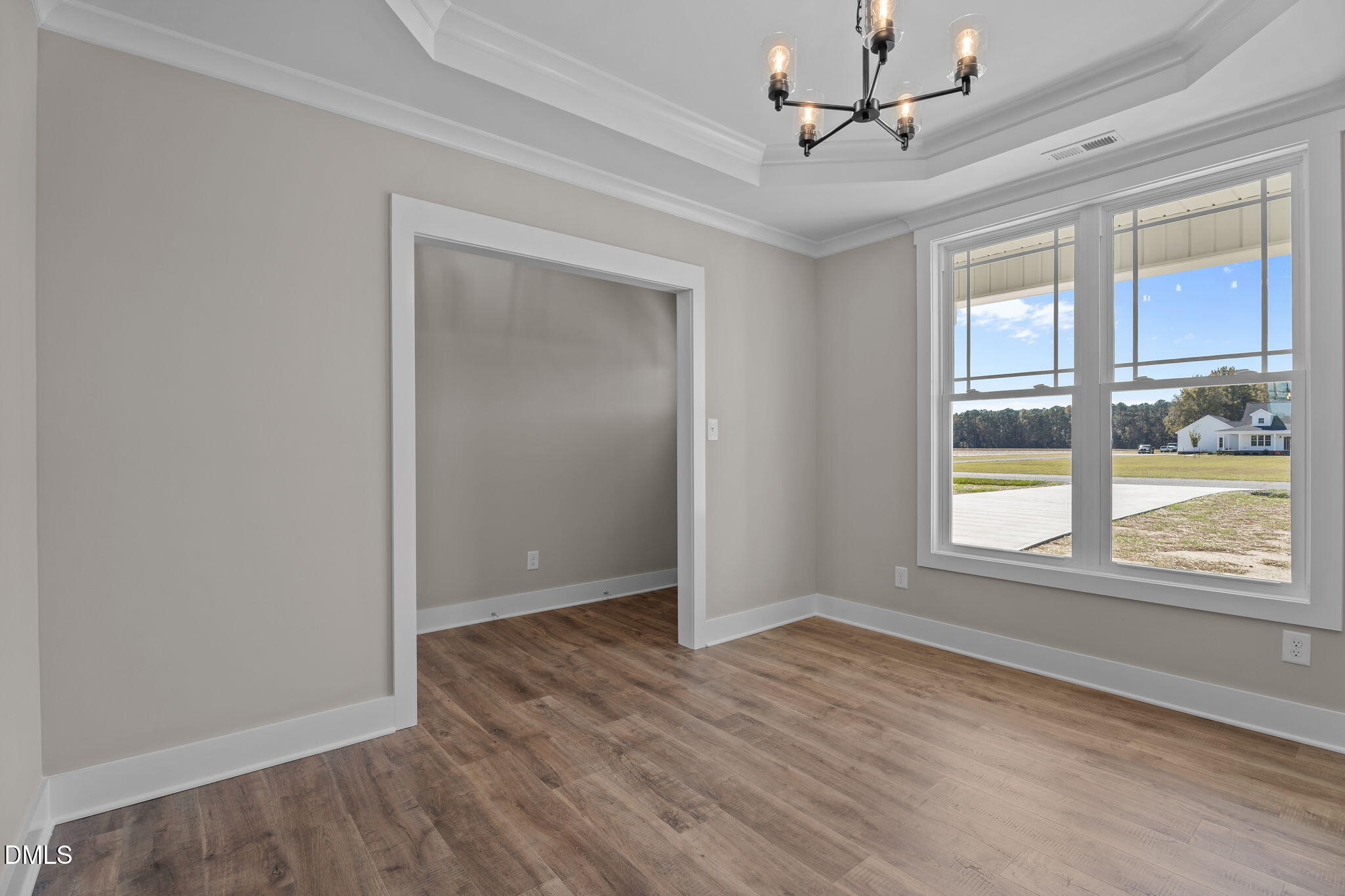 262 Fields Road Pikeville, NC 27863 - Photo 13 of 43 a view of an empty room with a window and wooden floor