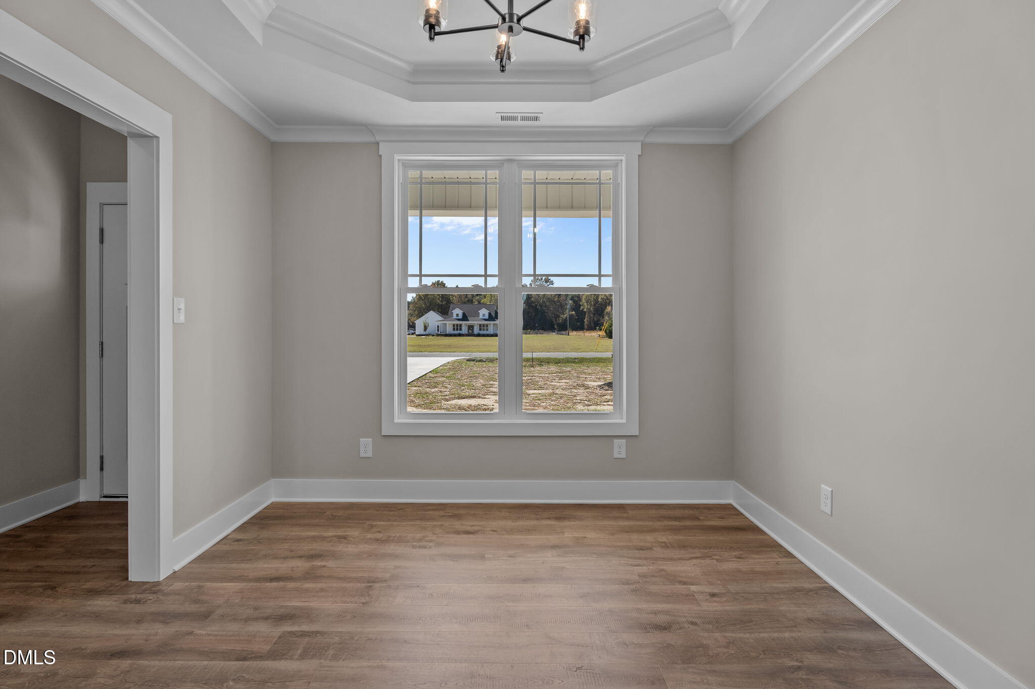 262 Fields Road Pikeville, NC 27863 - Photo 15 of 43 an empty room with a window and a chandelier fan