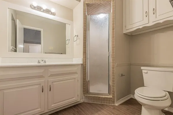 a bathroom with a toilet sink and vanity