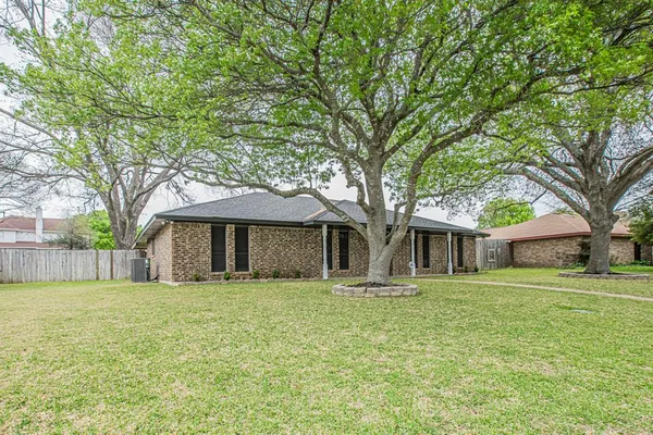 a front view of house with yard and trees