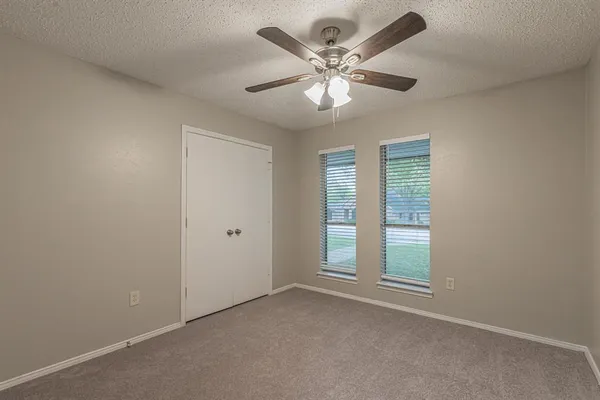 a view of a livingroom with a ceiling fan and window