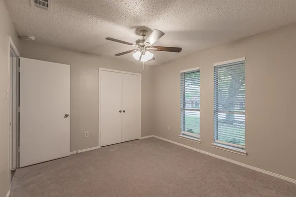 a view of a livingroom with a ceiling fan and window