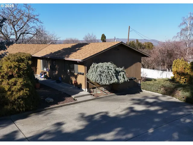 a view of a street with some trees in the background