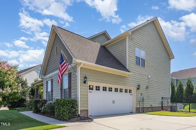 a view of a house with a yard and garage