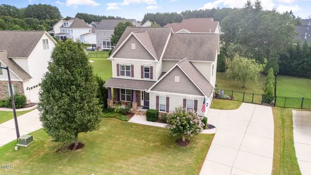 a large kitchen with granite countertop a sink and dishwasher a stove top oven with wooden floor