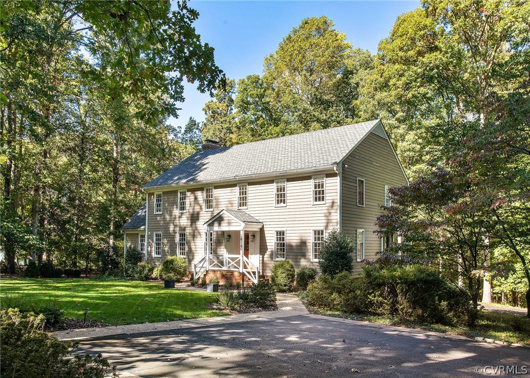 14140 Netherfield Drive Midlothian, VA 23113 - Photo 1 of 48 a view of a white house next to a yard with big trees
