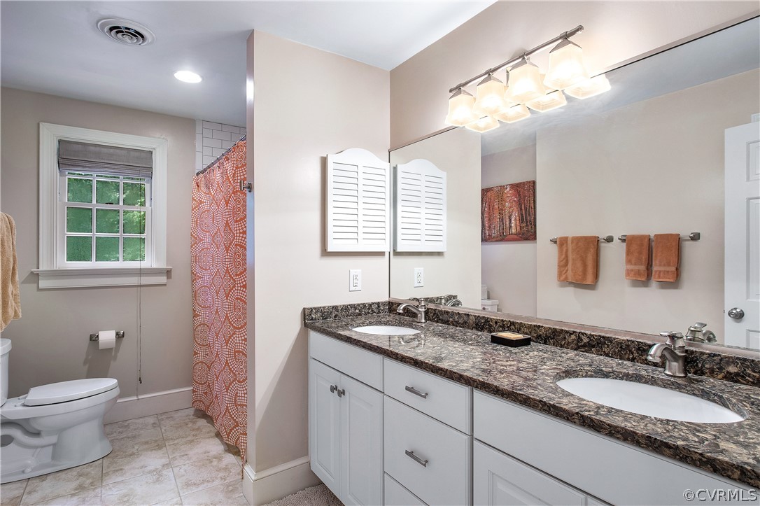14140 Netherfield Drive Midlothian, VA 23113 - Photo 35 of 48 a bathroom with a granite countertop double vanity sink a mirror and a toilet