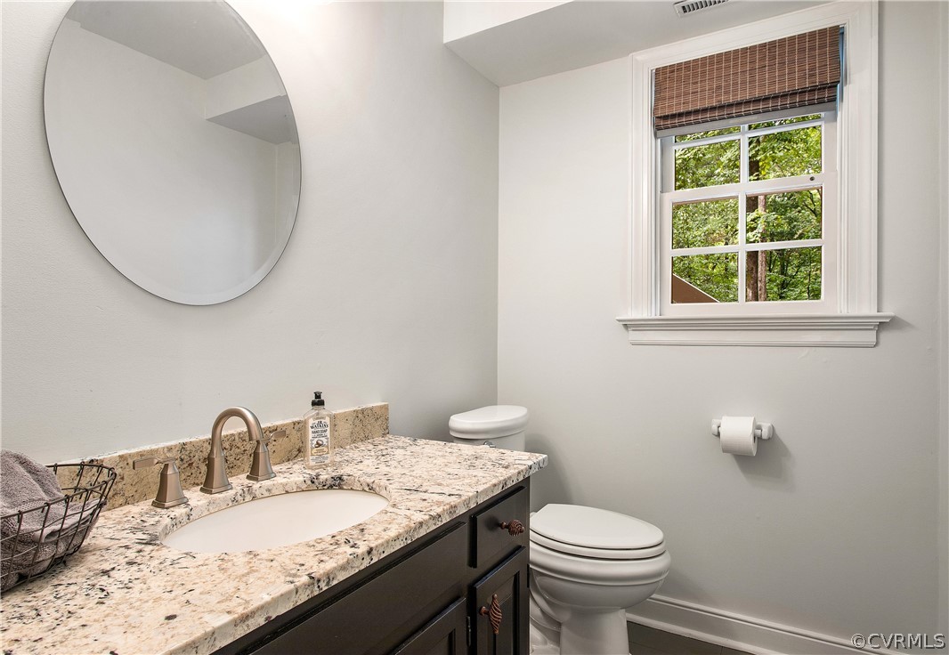 14140 Netherfield Drive Midlothian, VA 23113 - Photo 41 of 48 a bathroom with a granite countertop sink a toilet and a mirror