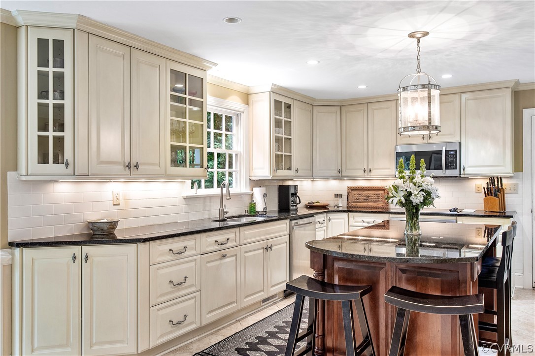 14140 Netherfield Drive Midlothian, VA 23113 - Photo 10 of 48 a kitchen with granite countertop a sink stove and white cabinets with wooden floor
