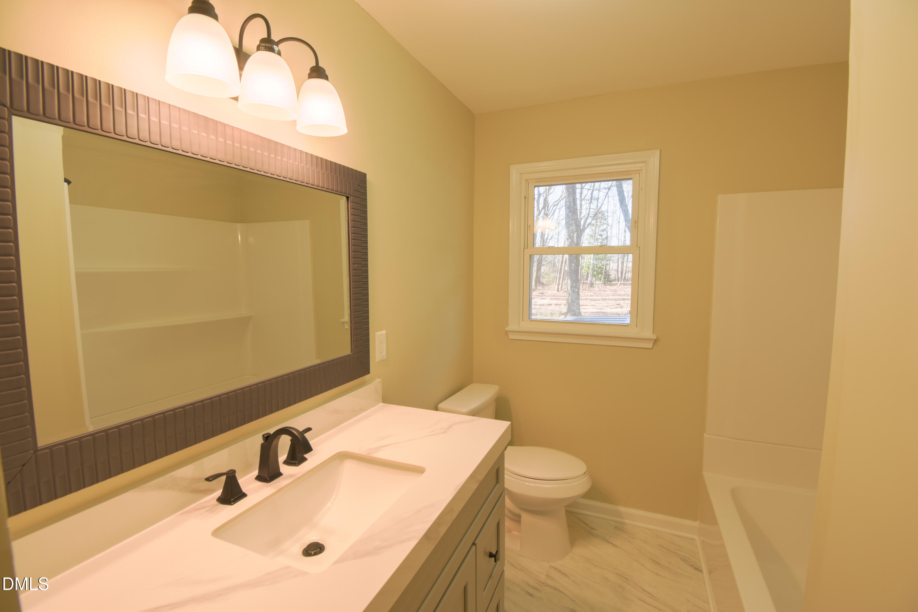 1412 Chamblee Road Zebulon, NC 27597 - Photo 13 of 22 a bathroom with a sink and a mirror