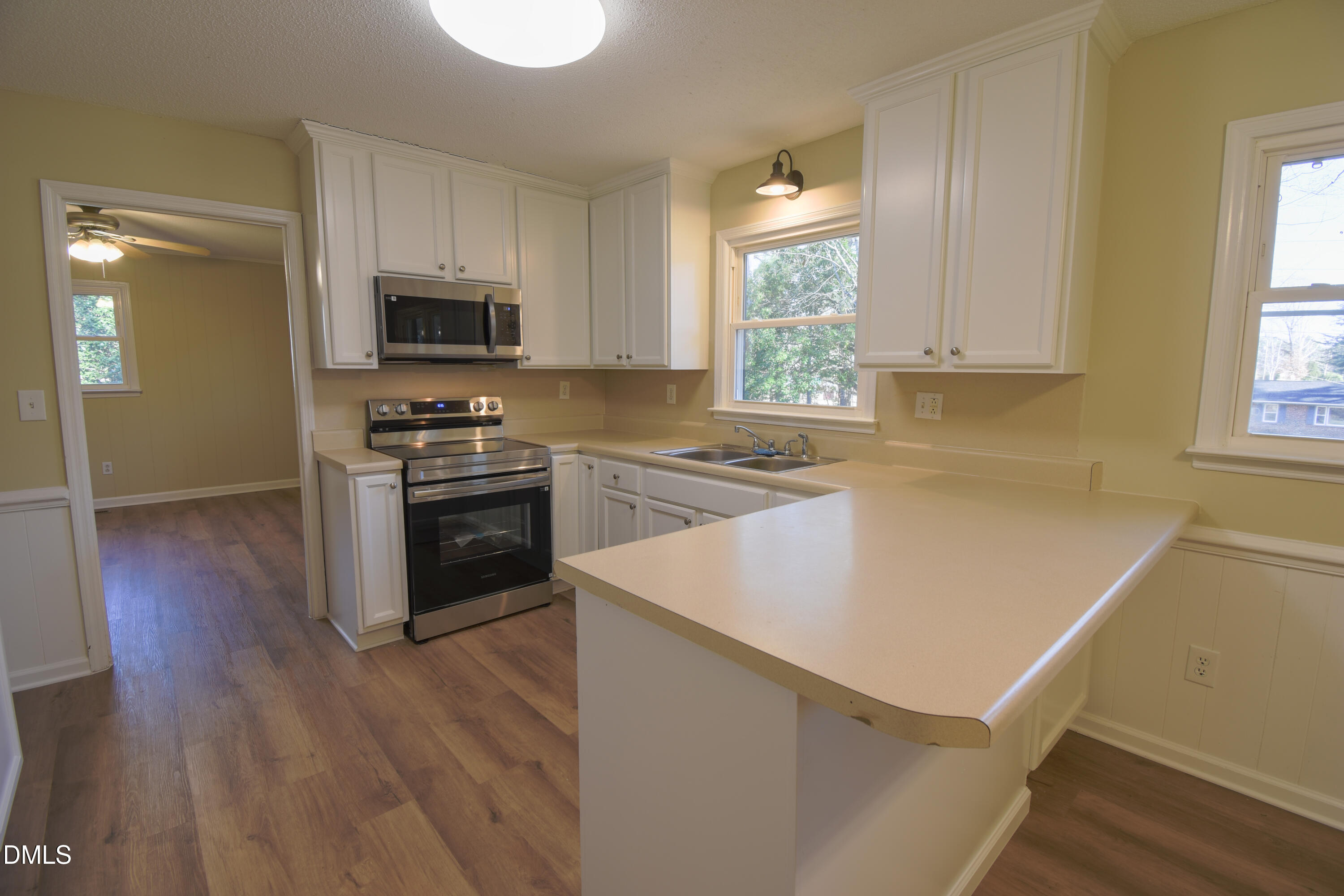 1412 Chamblee Road Zebulon, NC 27597 - Photo 4 of 22 a kitchen with a stove a sink and a microwave