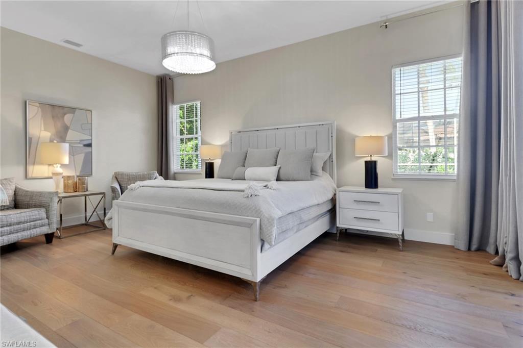 2127 Harlans Run Naples, FL 34105 - Photo 11 of 22 a bedroom with a bed and a chandelier