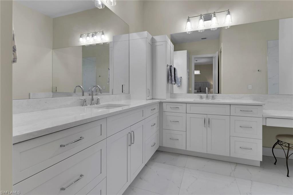2127 Harlans Run Naples, FL 34105 - Photo 12 of 22 a bathroom with a sink and a mirror