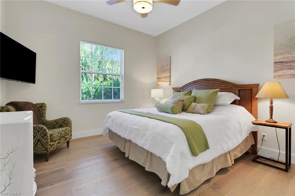 2127 Harlans Run Naples, FL 34105 - Photo 14 of 22 a bedroom with bed and a flat tv screen on dresser