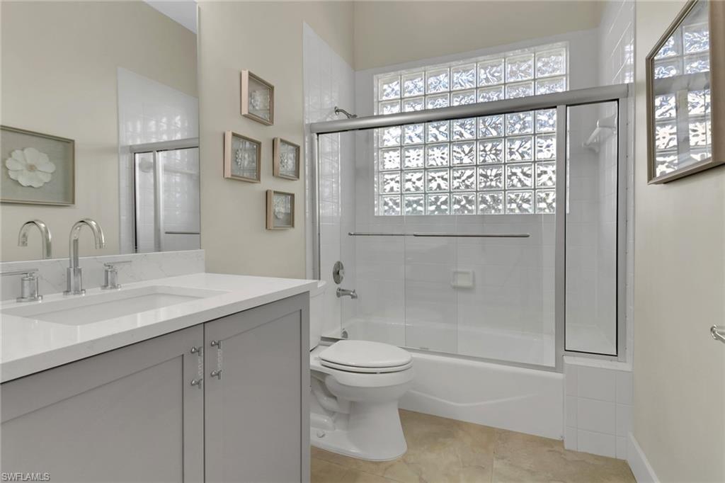 2127 Harlans Run Naples, FL 34105 - Photo 15 of 22 a bathroom with a granite countertop sink a toilet and shower