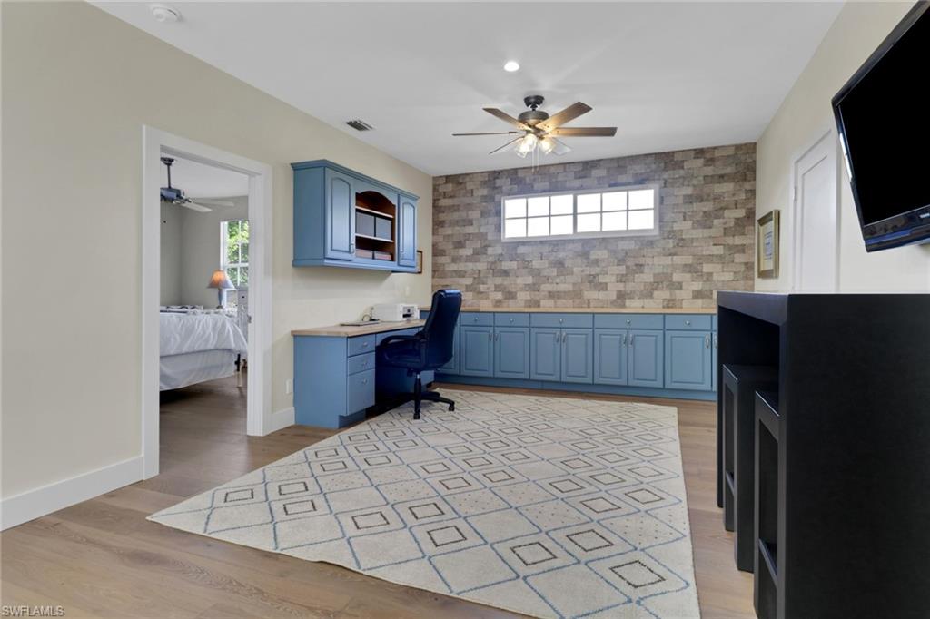 2127 Harlans Run Naples, FL 34105 - Photo 16 of 22 a kitchen with granite countertop a sink and a stove top oven