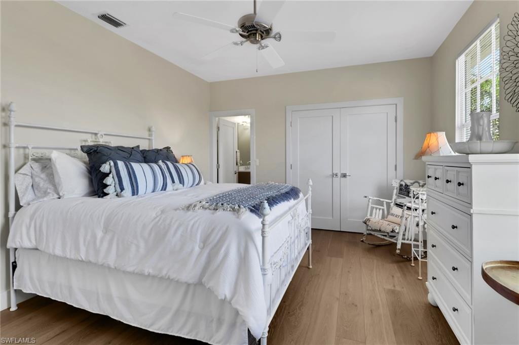 2127 Harlans Run Naples, FL 34105 - Photo 17 of 22 a spacious bedroom with a bed and a couch