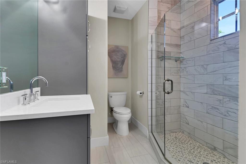 2127 Harlans Run Naples, FL 34105 - Photo 18 of 22 a bathroom with a sink a toilet and shower